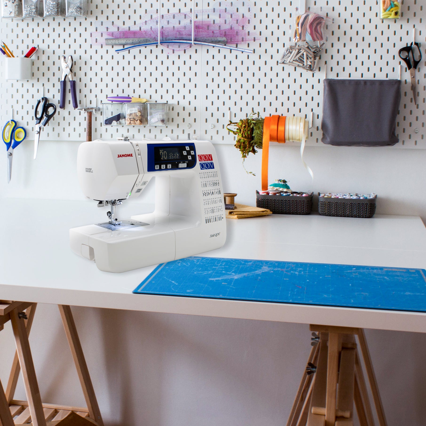 image of the Janome 3160QOV Quilts of Valor Sewing and Quilting Machine on a table