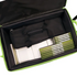 An open bright green and black carrying case or organizer filled with black fabric pouches and several slim green-and-white books or folders, photographed on a white background.