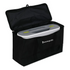 A black fabric storage bag with the lid open, containing a white and gray AccuQuilt machine. The brand name 'Accuquilt' is printed in white on the front pocket of the bag.
