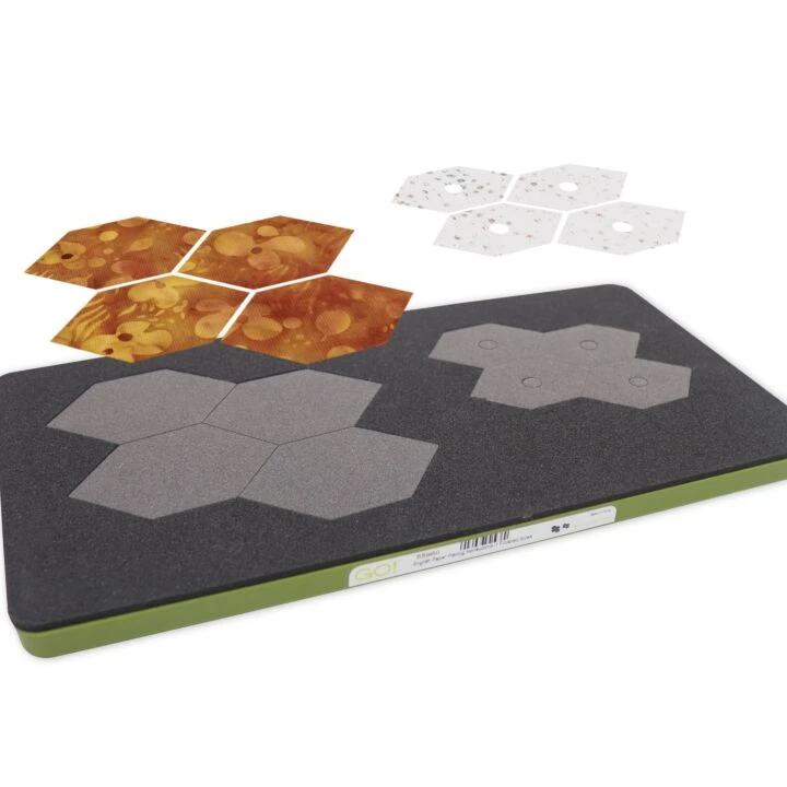 A rectangular black textured mat with a green edge, shown on a white background with several hexagonal sample pieces in gray, orange, and white.
