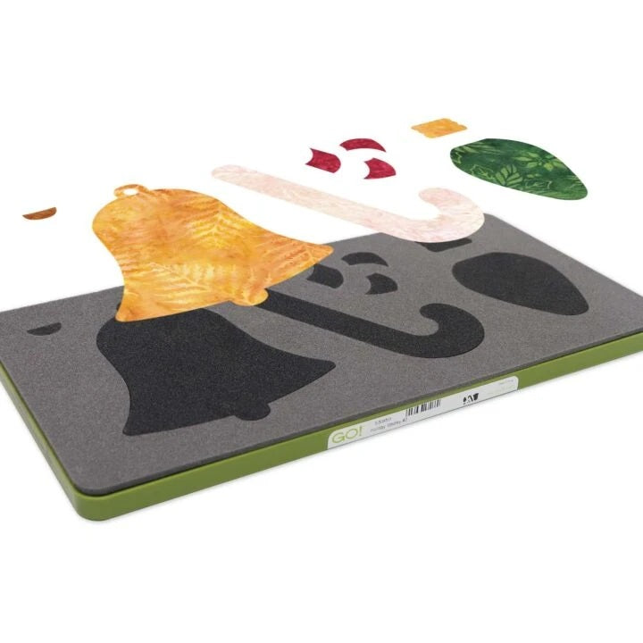 A DIY mosaic tile tray kit, featuring a dark gray rectangular tray with a green edge and a black bell-shaped cutout, shown alongside various colorful mosaic tile pieces on a white background.