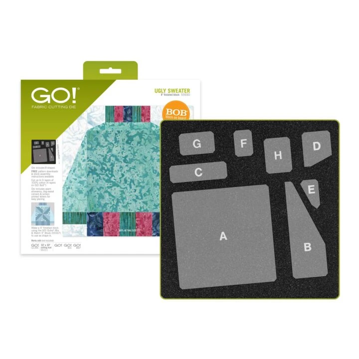 A GO! Knitwear 'Ugly Sweater' garment patch kit shown with its retail packaging. The kit includes a black fabric patch board with gray lettered sections labeled A, B, C, D, E, F, G, and H, alongside the white and green product box featuring a teal patterned swatch.