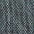 A close-up of a dark gray textured fabric covered in a repeating pattern of small circular dots.
