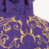 Purple fabric with gold embroidery on a white background