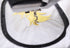 Close-up of an embroidery machine stitching a yellow and white floral design onto white fabric inside a black hoop.