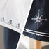 Nautical-themed clothing with compass design and embroidered figures on a white background