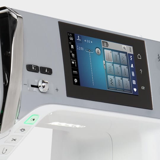 Close-up of a sewing machine's control panel with digital display and buttons.