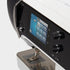 Close-up of a sewing machine with digital display and control knobs on a white background