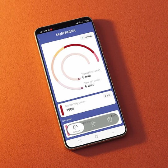 Smartphone displaying a sewing app app on an orange background
