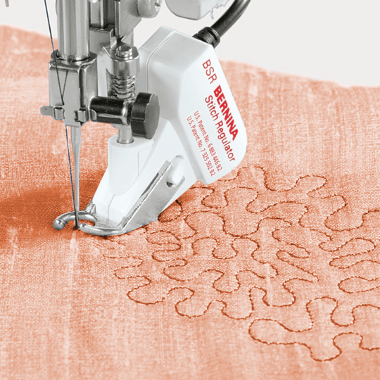 BERNINA Stitch Regulator on a piece of fabric with intricate stitching pattern