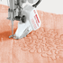 BERNINA Stitch Regulator on a piece of fabric with intricate stitching pattern