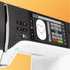 Close-up of a sewing machine's digital display and control panel with a white screen.