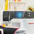 A BERNINA B 790 PRO sewing machine in white and black, shown in a bright, softly blurred sewing room setting with a quilt visible under the needle.