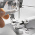 Close-up of a sewing machine needle and thread
