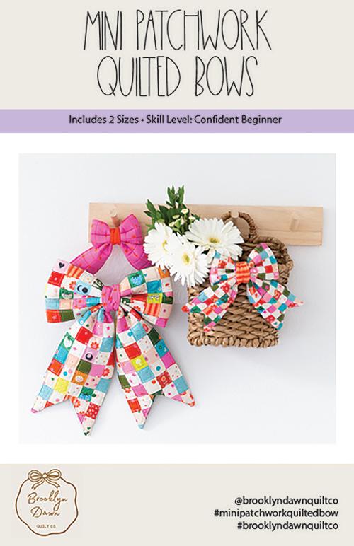 Mini patchwork quilted bows with a wooden board and flowers on a white background