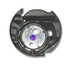 Close-up of a bobbin case with a purple dot on a white background