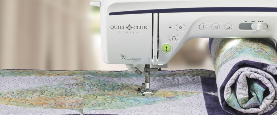 Quilting machine with a quilt on a table