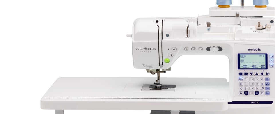 White sewing machine with digital display on a white background