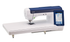 Brother BX1 sewing machine with an extended white quilting table and a blue digital touch screen display, shown on a solid white background.