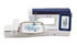 A Brother embroidery machine in white and navy blue, shown with an embroidery hoop containing a blue snowflake design on white fabric, against a solid white background.