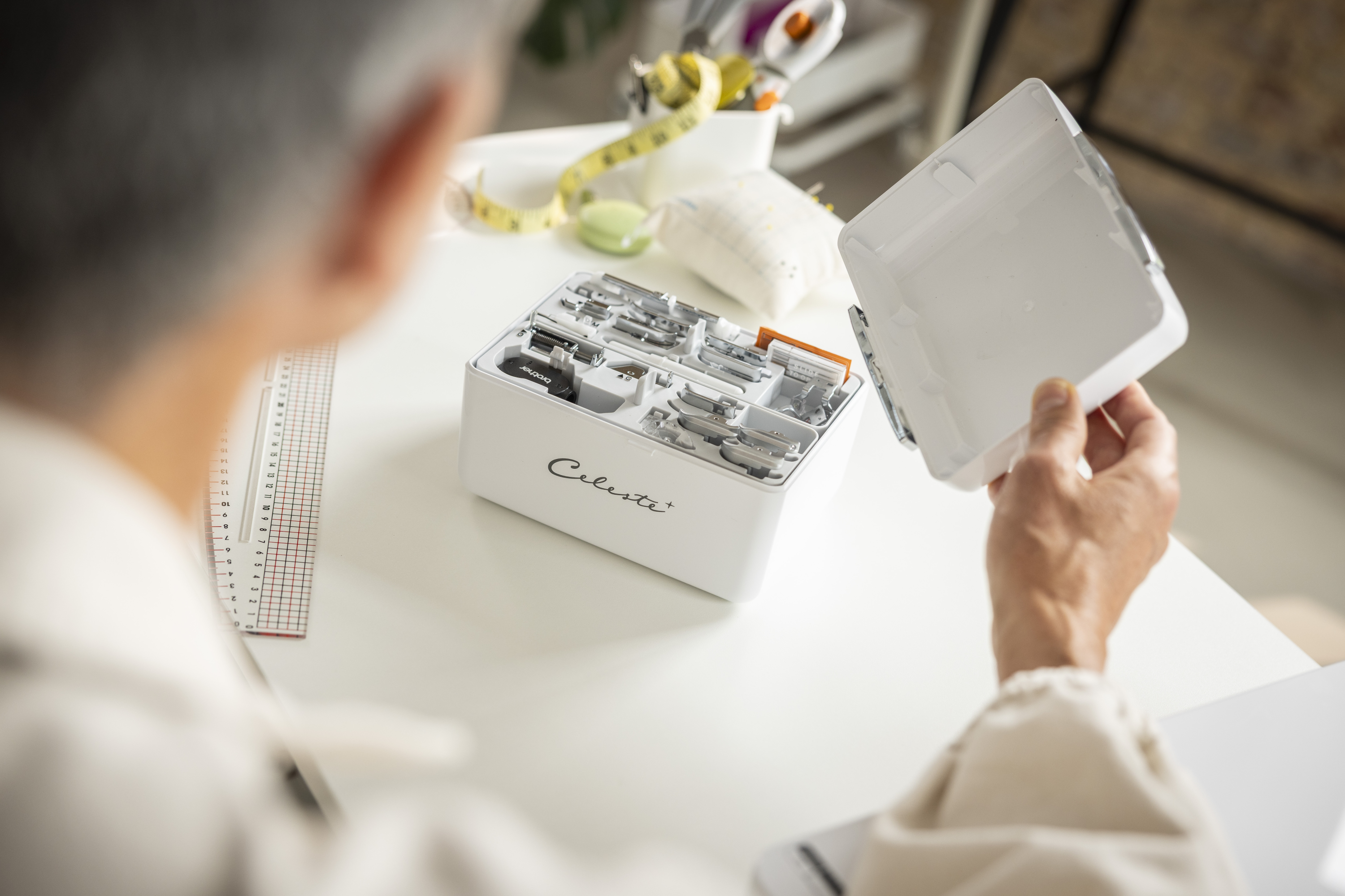 Person holding a white box with Celeste accessories