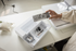 Set of sewing machine accessories in a box on a white surface