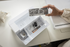 Set of sewing machine accessories in a box on a white surface