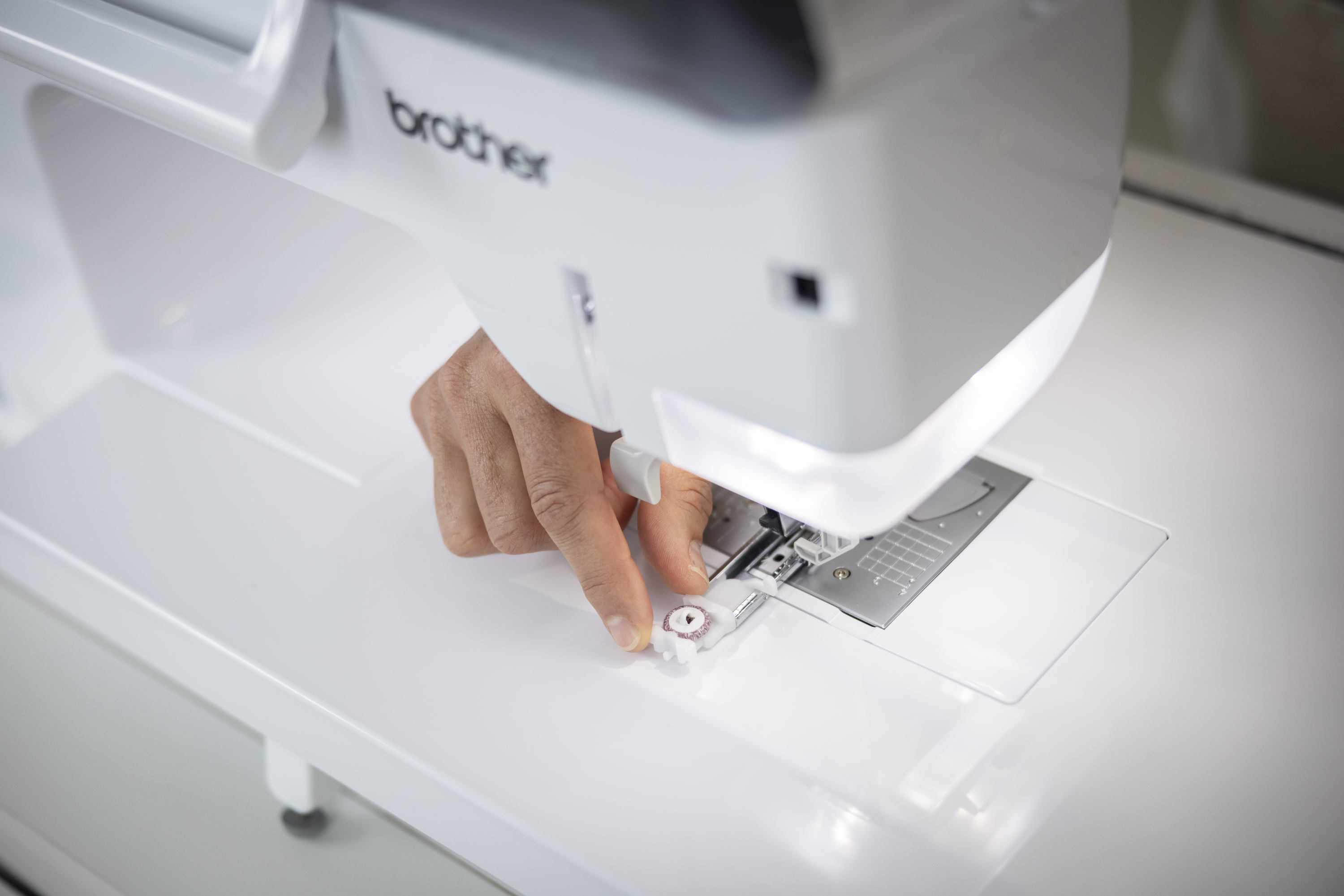 Person using a Brother sewing machine