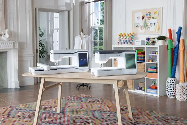 Two sewing machines on a wooden table in a home office setting.