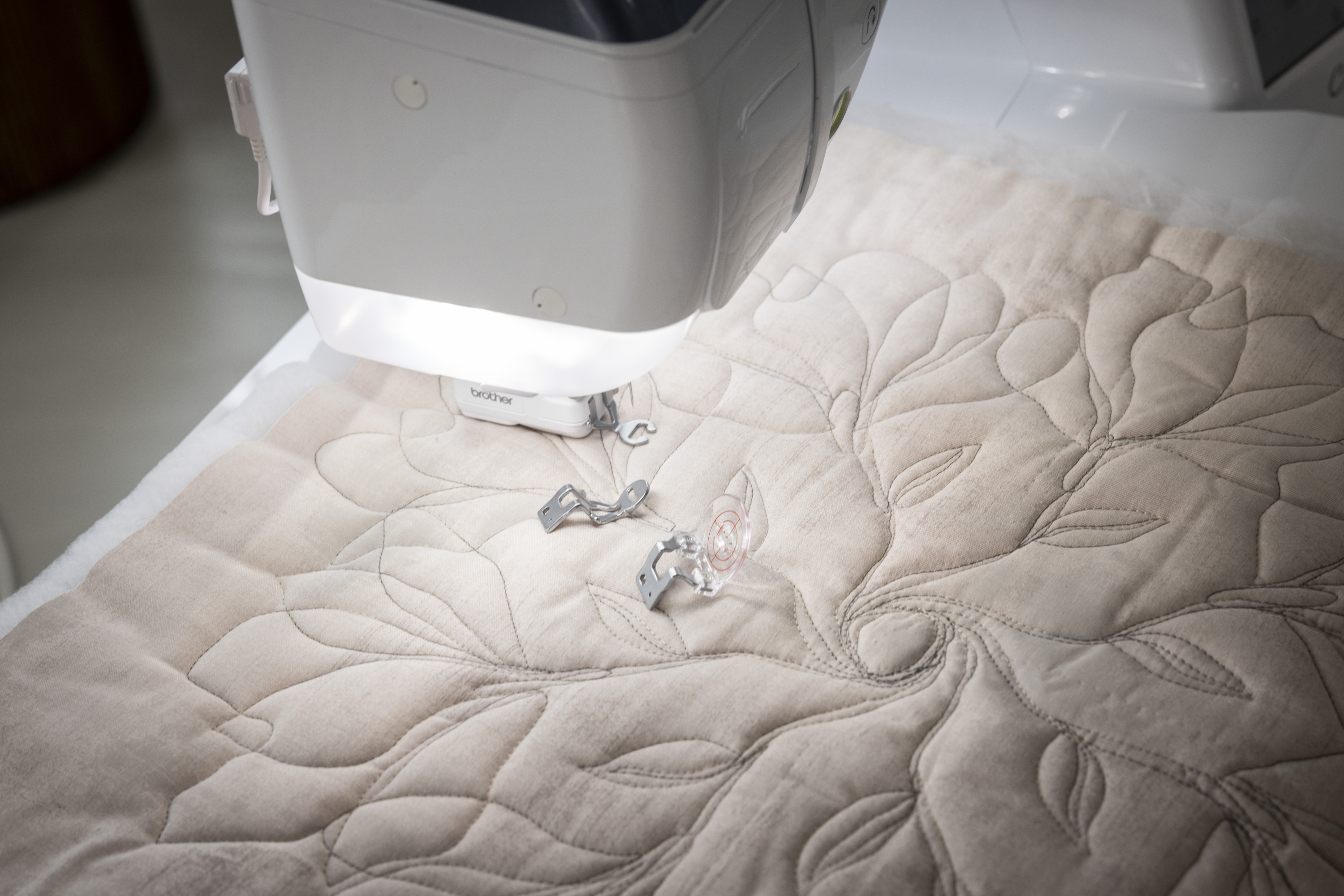 Quilted fabric on a sewing machine with a light shining on it