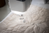 Quilted fabric on a sewing machine with a light shining on it