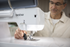 Person using a Brother sewing machine with a blurred background