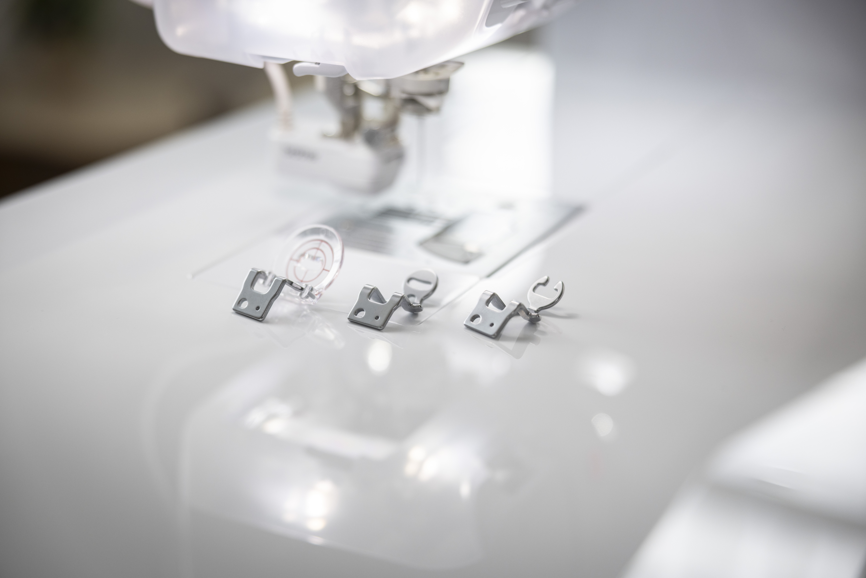 Close-up of presser feet on a white sewing machine