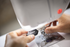 Person replacing a Brother sewing machine needle with another one.