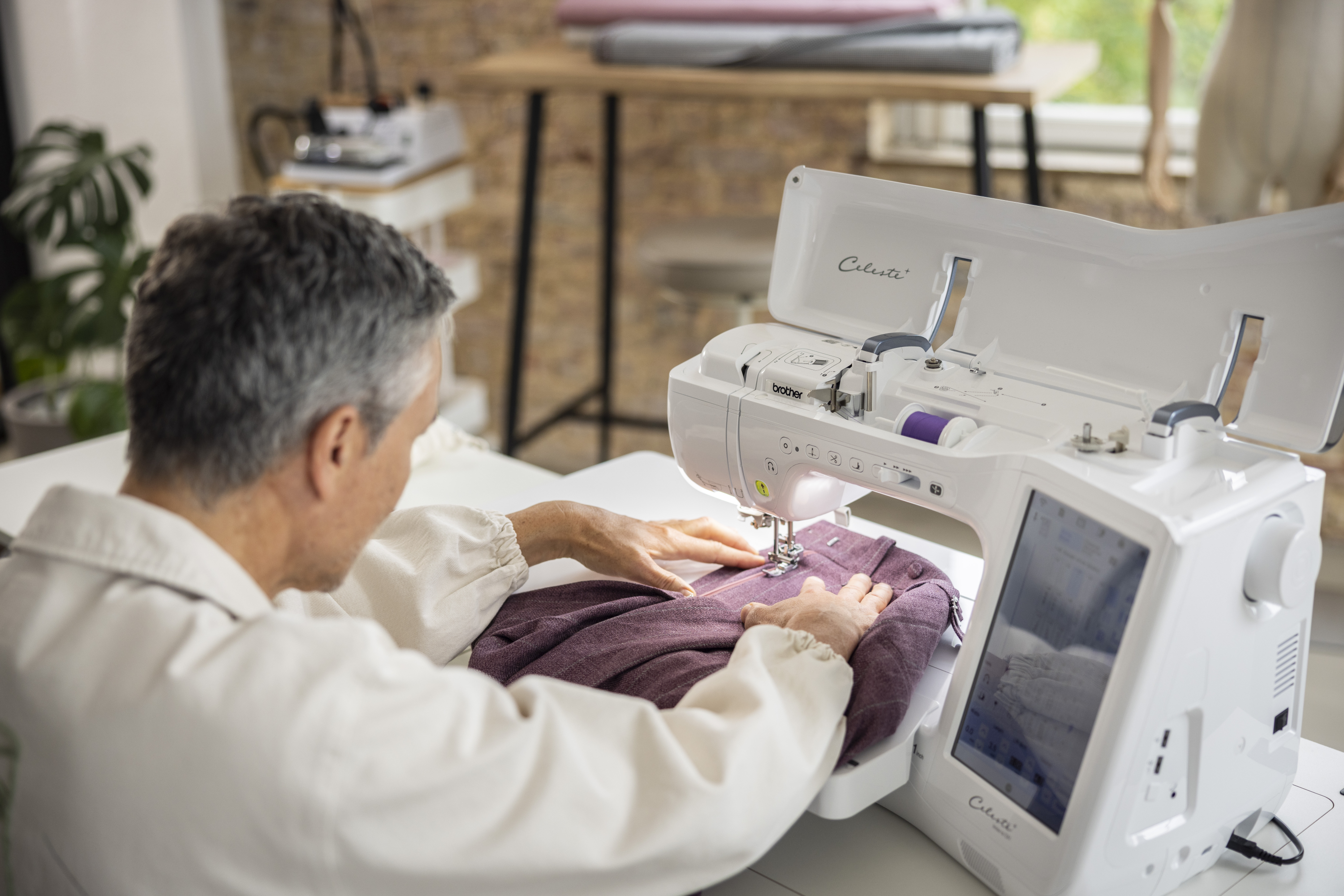 Person using a sewing machine in a home setting
