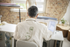Person sitting at a desk using a computer in an office setting