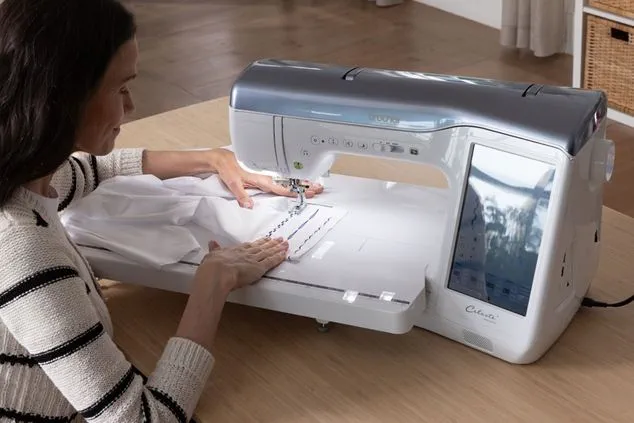 Woman using a sewing machine on a wooden table