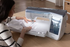 Woman using a sewing machine on a wooden table