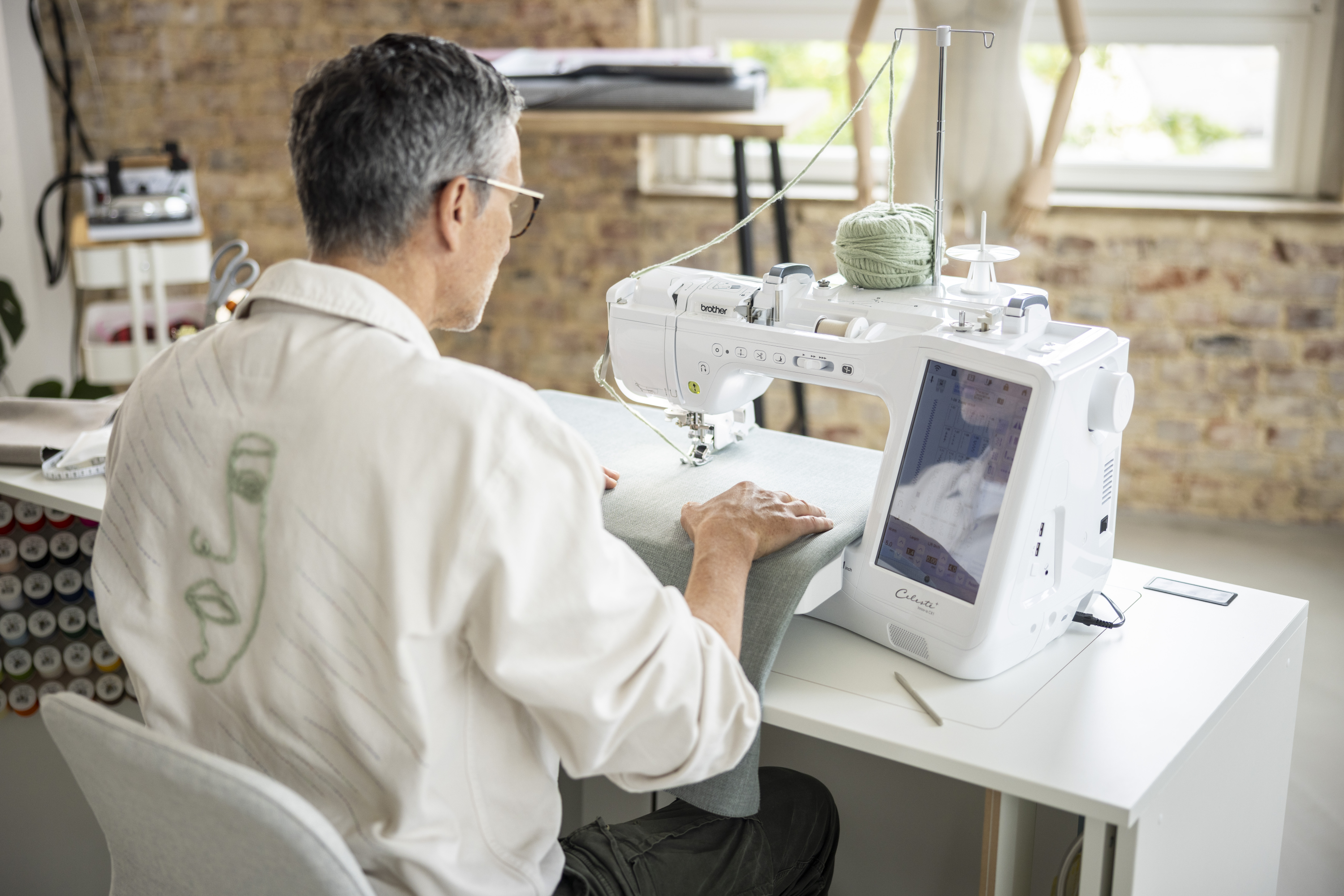 Man using a sewing machine in a home setting