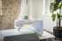 Sewing machine on a table with a plant in the background