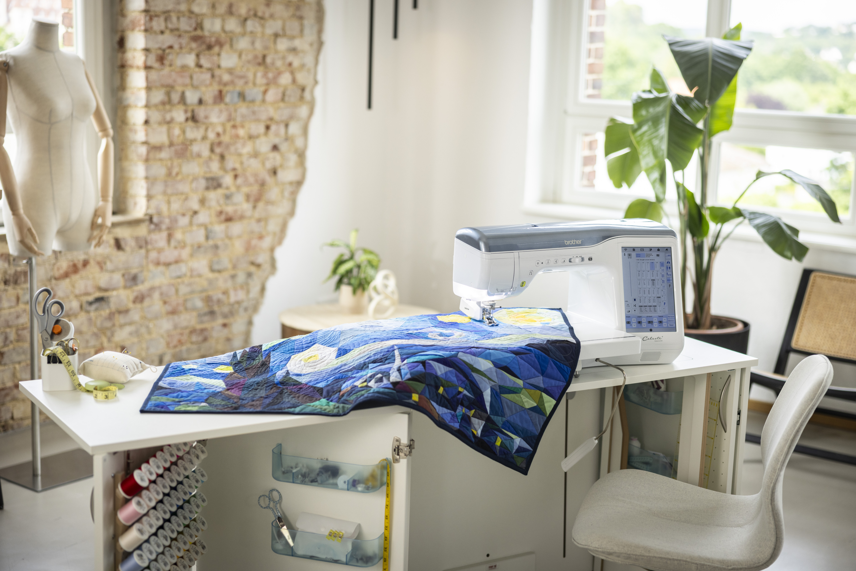 Sewing machine with a colorful fabric on a table in a well-lit room.