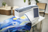 Sewing machine with a quilt on a table in a room setting