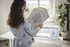 Woman using embroidery machine with design on screen