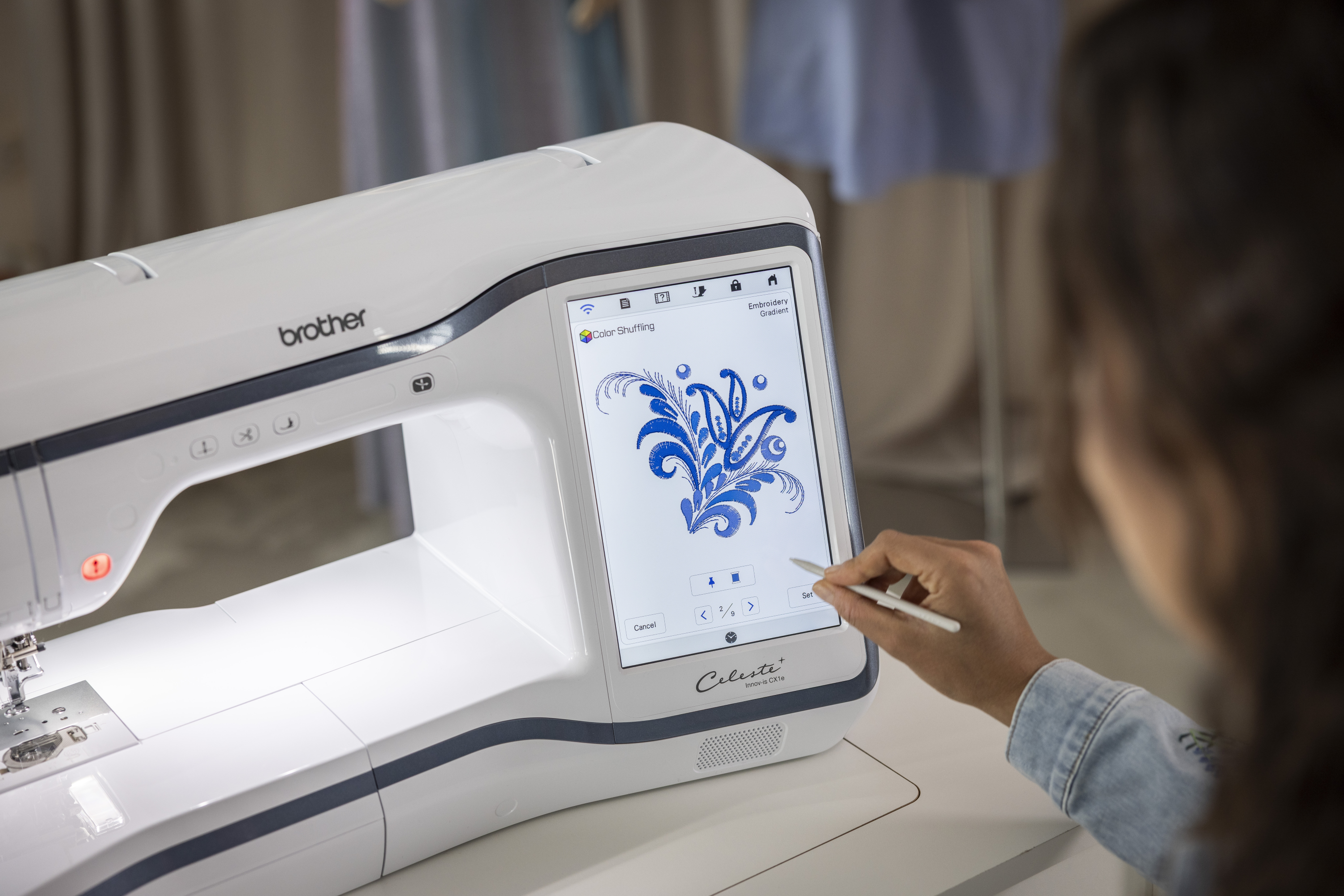 Person using a Brother embroidery machine with a digital display