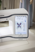 Embroidery machine with a butterfly design on the screen