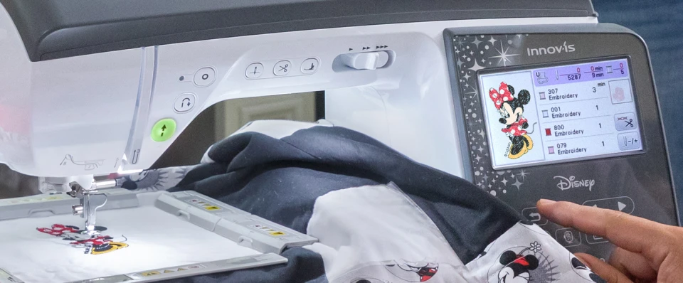 Sewing machine with Disney character design on the screen