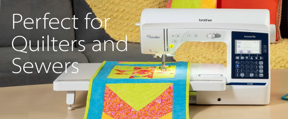 A Brother Quillcraft embroidery machine with a colorful quilted fabric sample on its needle, set against a cozy background with a gray sofa and yellow pillows. Large white text on the left reads 'Perfect for Quilters and Sewers'.