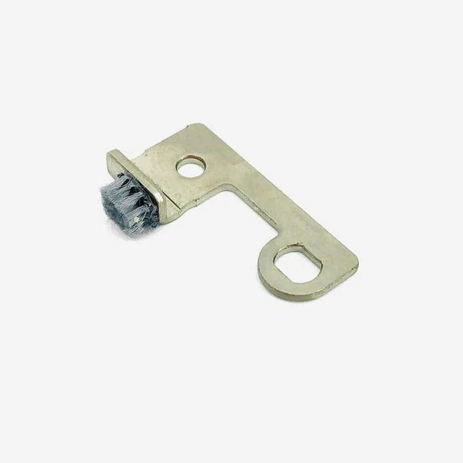 A small metal tool or replacement part with a looped handle and a short bristle brush on one end, shown on a plain light background.