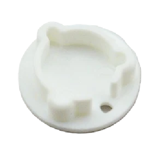 A small white plastic circular component with a molded irregular shape and a small hole near the lower right edge, shown on a plain white background.