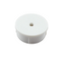 A small white plastic cylindrical cap or cover with a single central hole, shown on a plain white background.